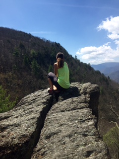 Amy perched above a valley
