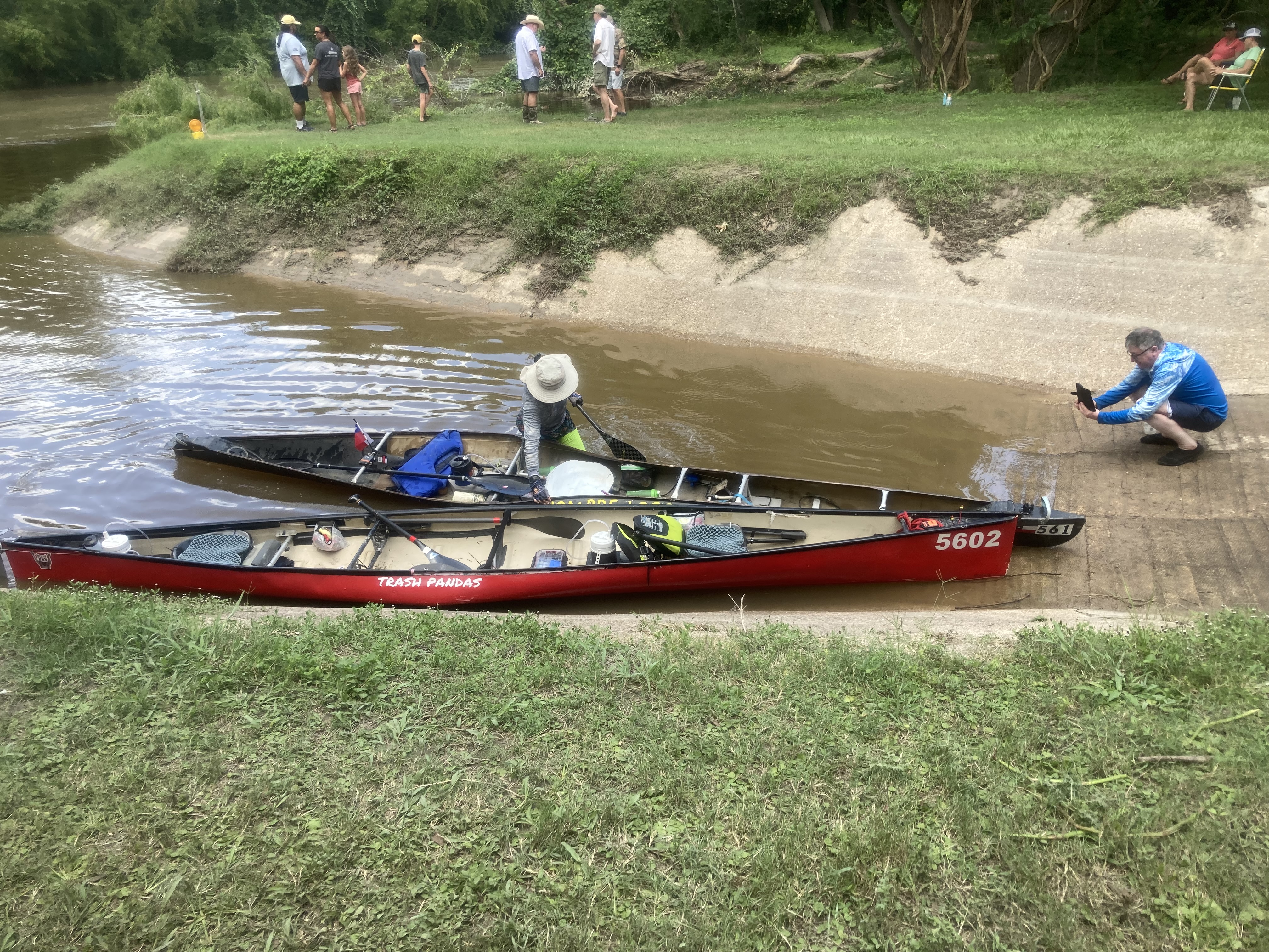 Trash Pandas and another team's boats pulled up at the flooded 2025 checkpoint
